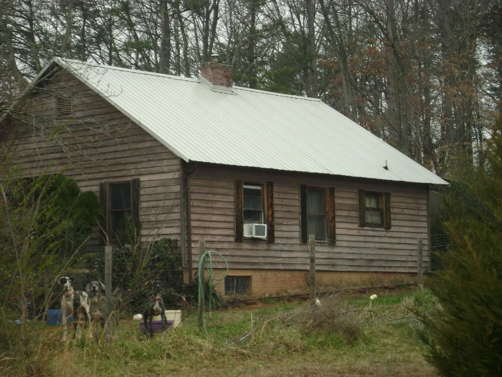 White metal roof on an old wood sided farmhouse, from a Metal Roof Installation job in Zion
